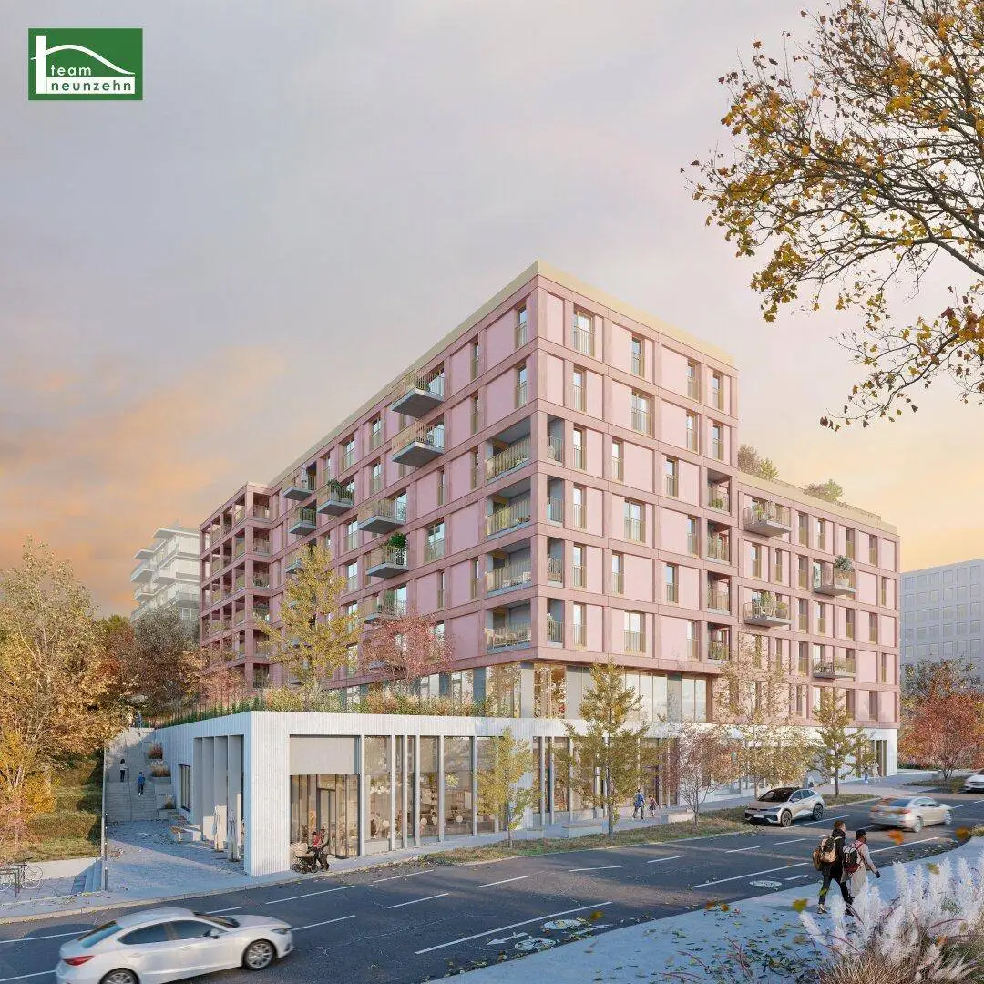 Visualisierung eines großen modernen Wohngebäudes mit rosafarbener Fassade und zahlreichen Balkonen.
